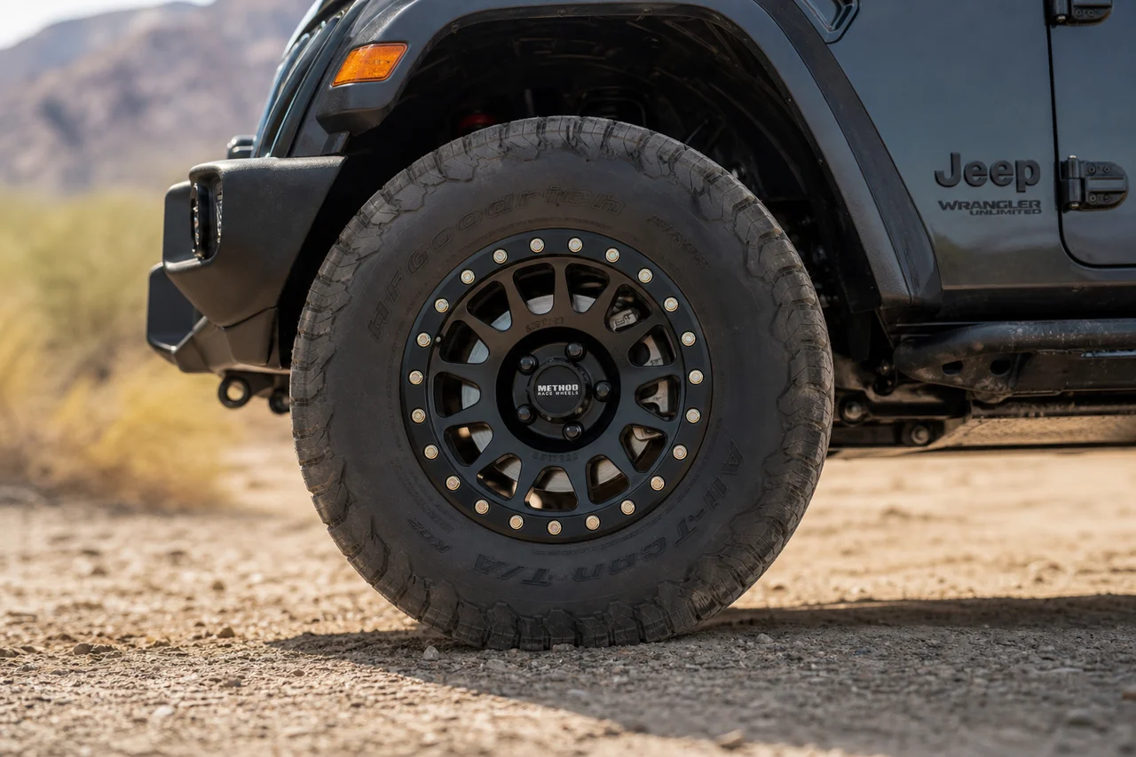 Best Jeep Wrangler Wheels for a Strong Off Road Setup Jeep Wrangler beadlock style wheel close up with 35 inch tire and fender clearance
